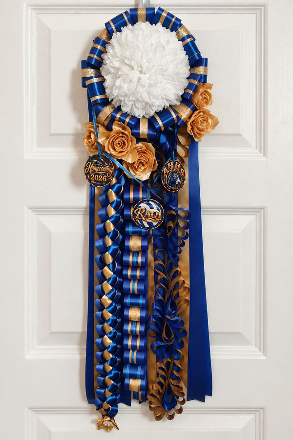 Royal blue and gold homecoming mum with a white flower, gold roses, and school charms, hanging on a door